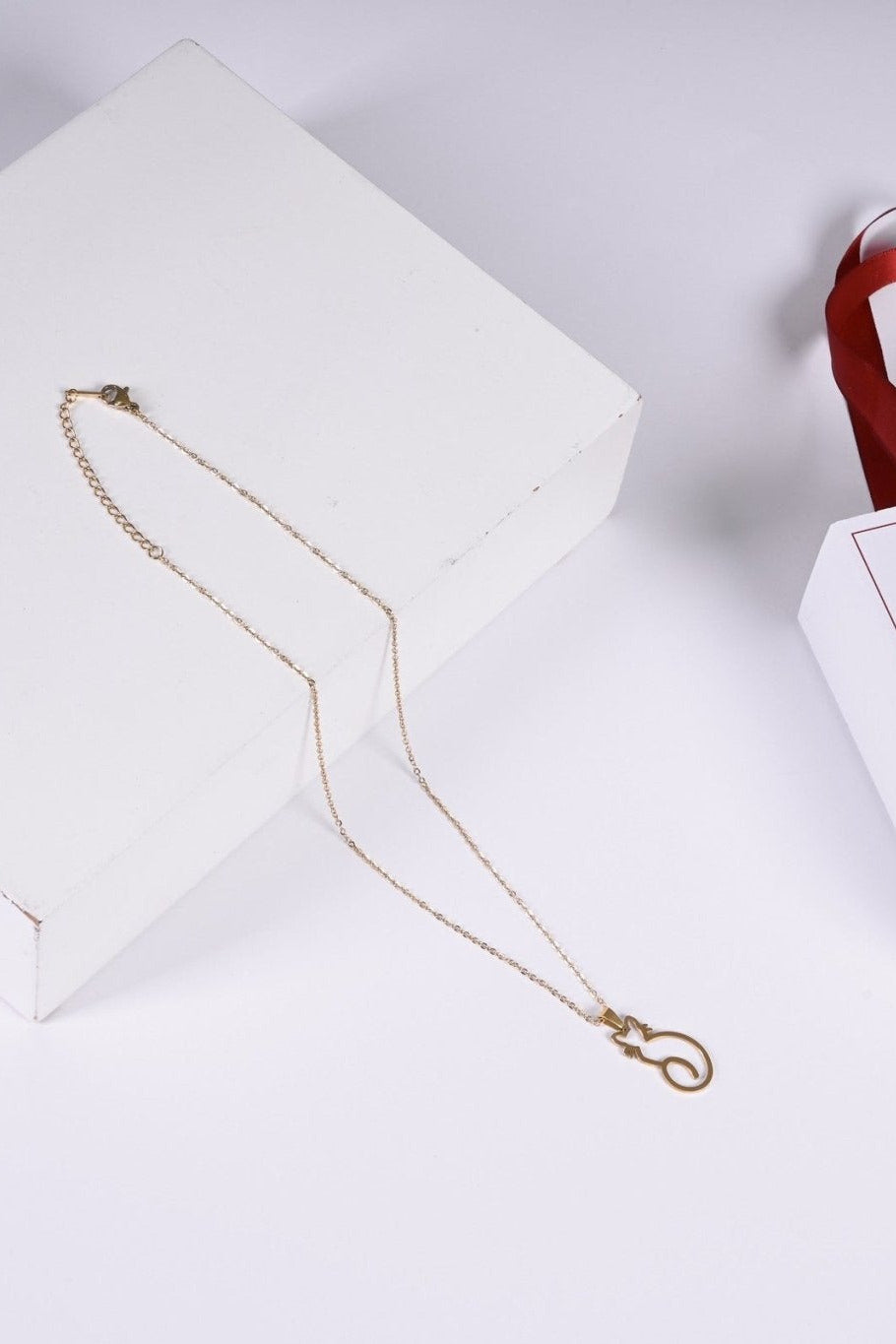 Cat outline pendant in gold — BALTO