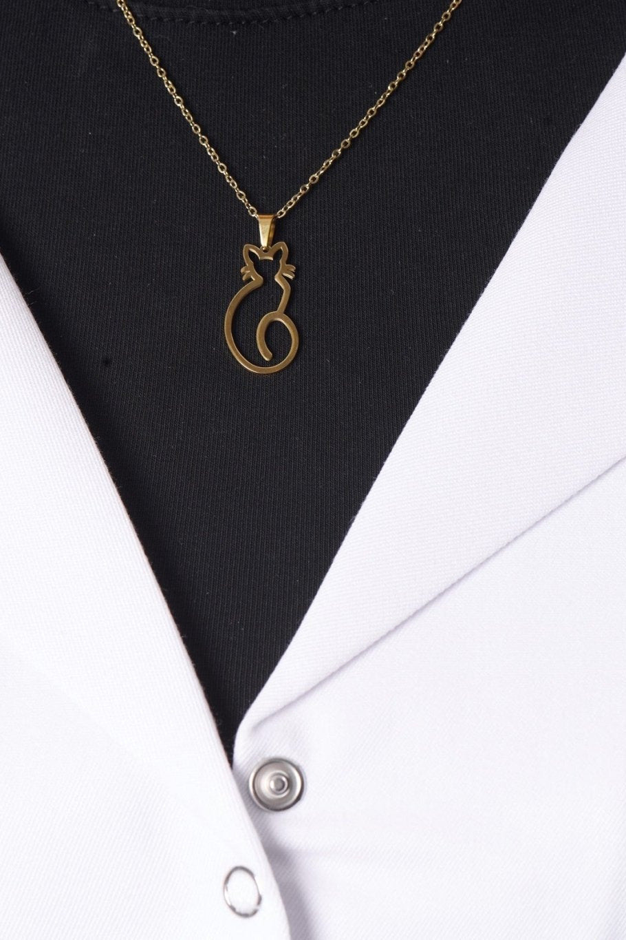 Cat pendant on model, BALTO lab coat