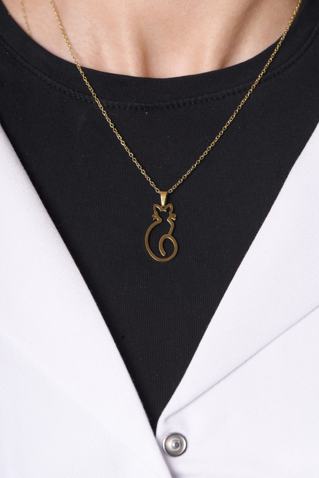 Cat pendant worn with a BALTO lab coat