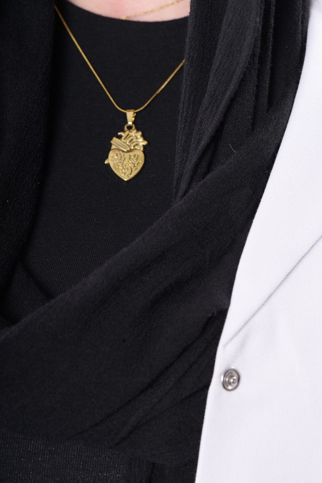 Engraved anatomical heart pendant worn with a BALTO lab coat