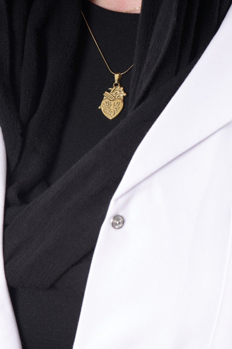 Engraved anatomical heart pendant on model, BALTO lab coat