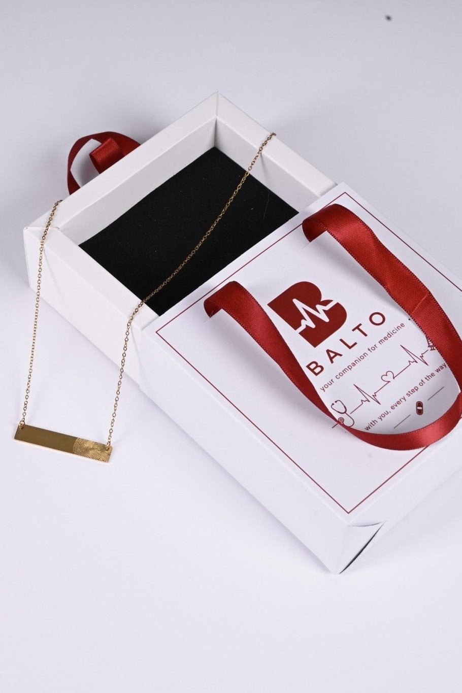 Gold fingerprint bar necklace in BALTO gift box