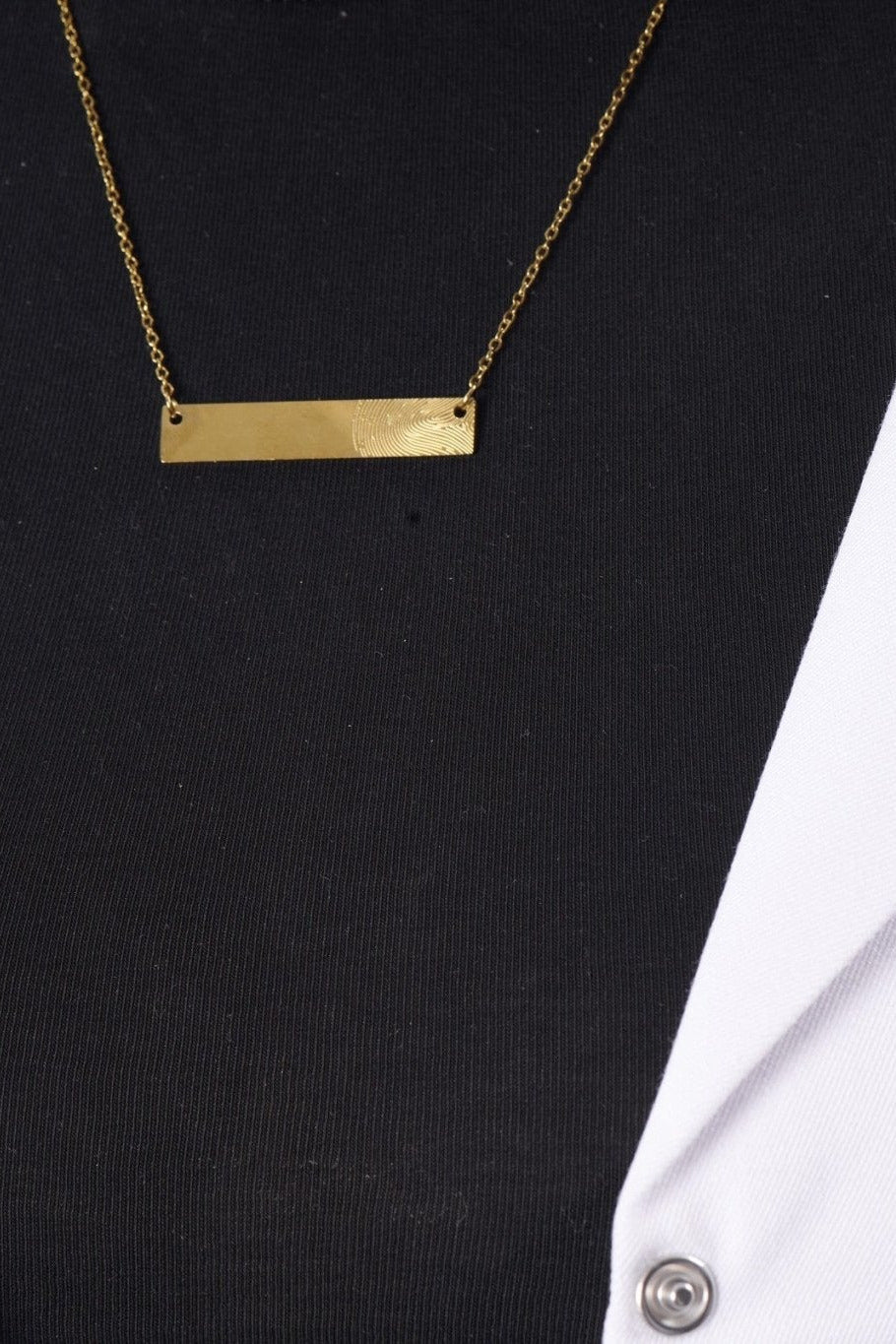 Fingerprint bar necklace on model, BALTO lab coat
