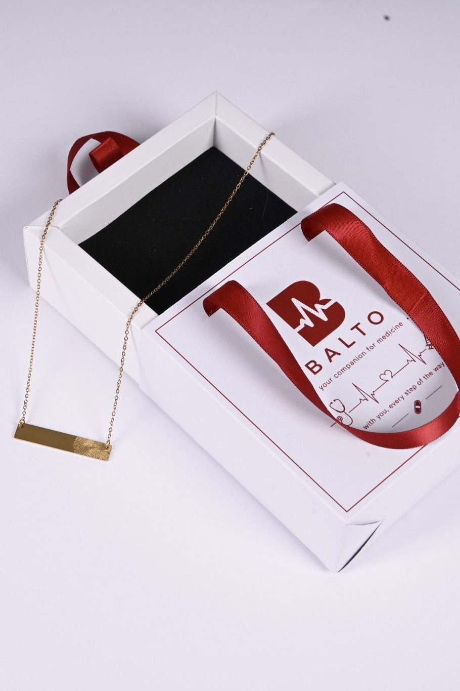 Gold fingerprint bar necklace in BALTO gift box