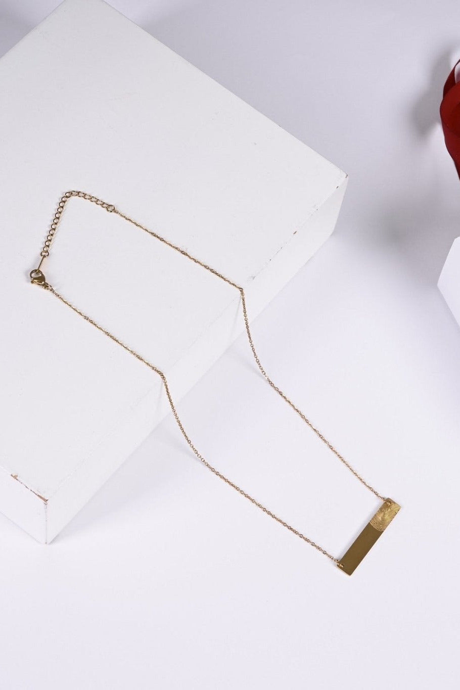 Gold fingerprint bar necklace with BALTO box and bag