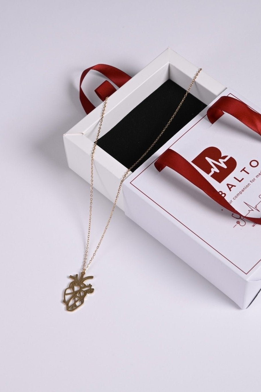 Gold anatomical heart pendant in BALTO gift box
