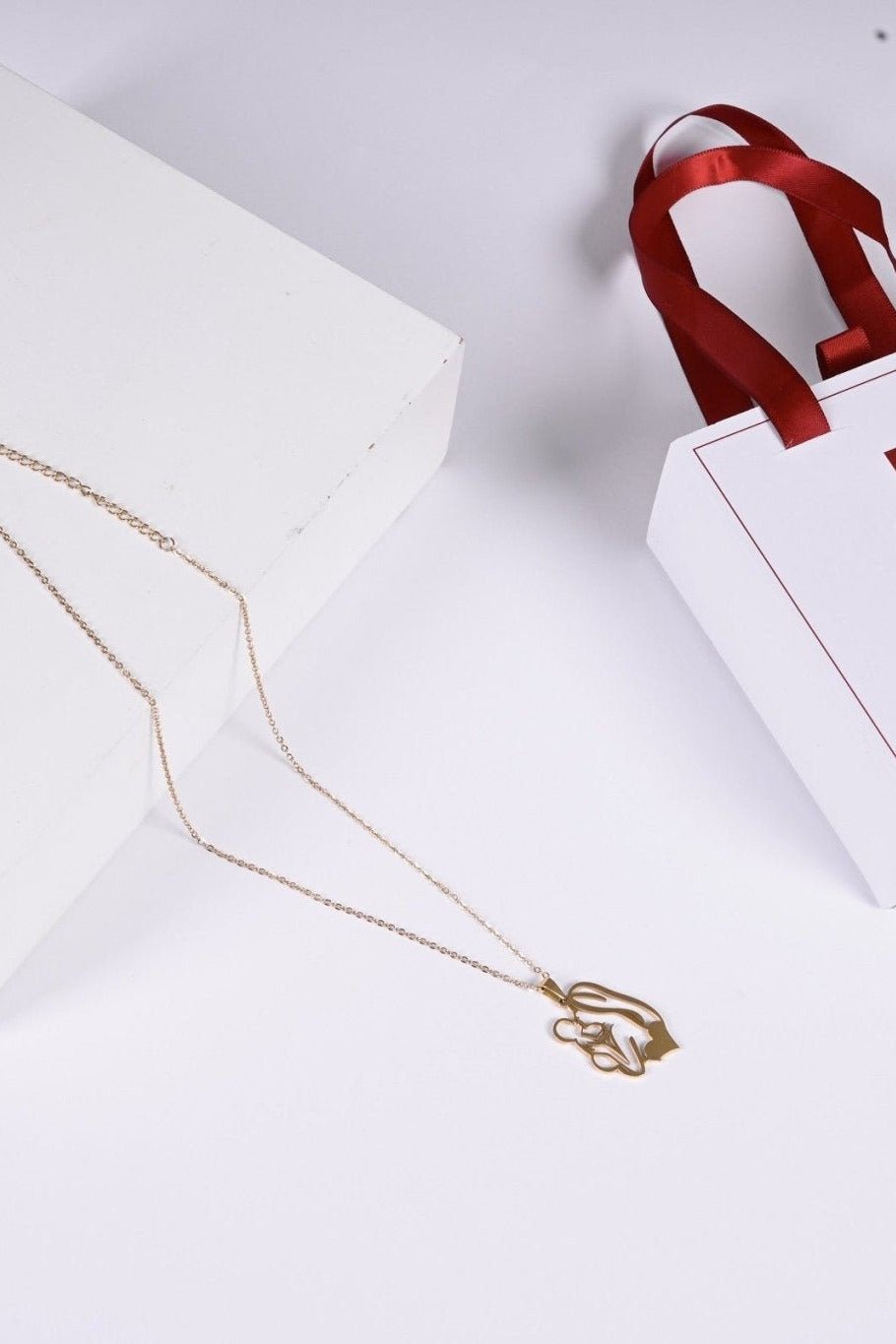 Gold mother and child pendant with BALTO box and bag