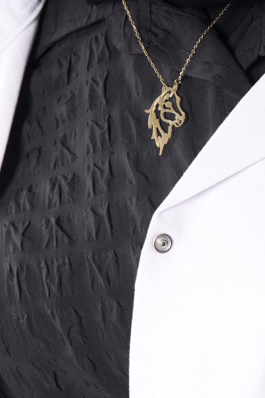 Horse pendant on model, BALTO lab coat