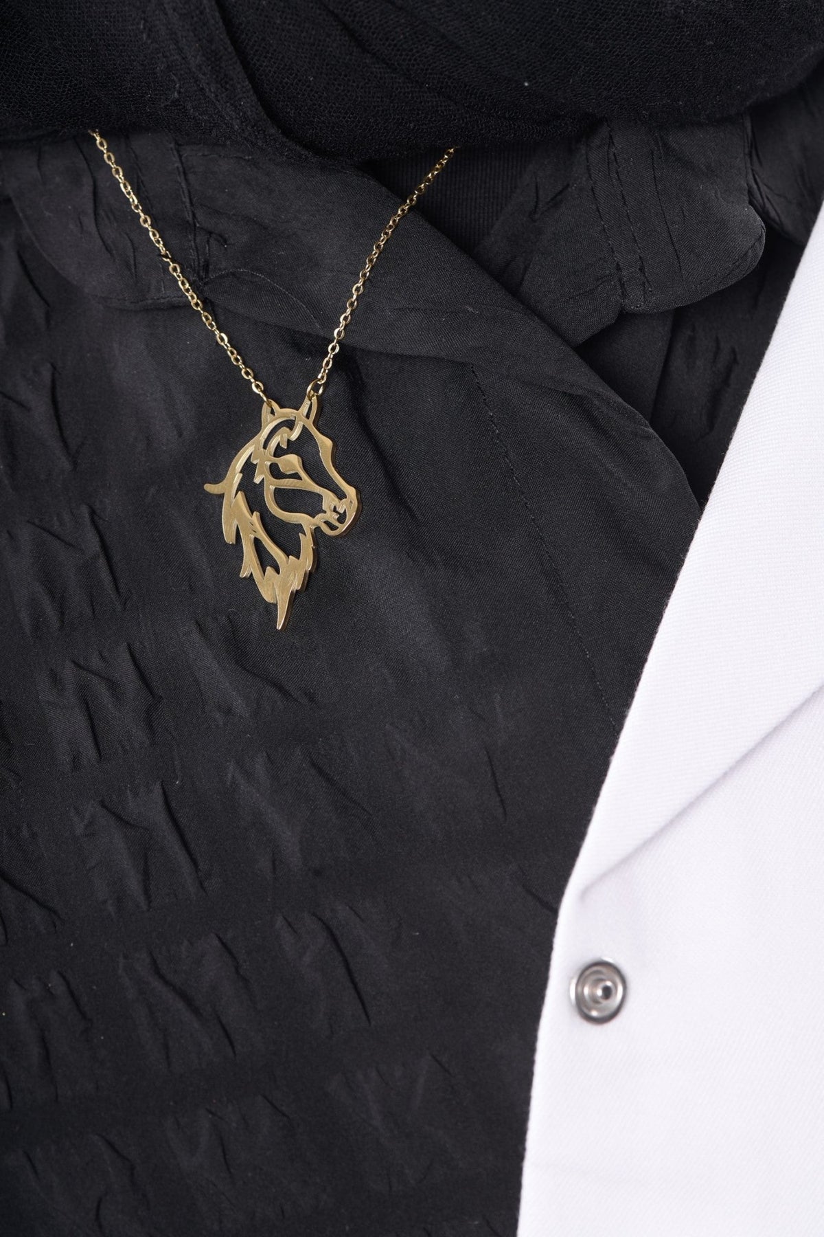 Horse pendant worn with a BALTO lab coat