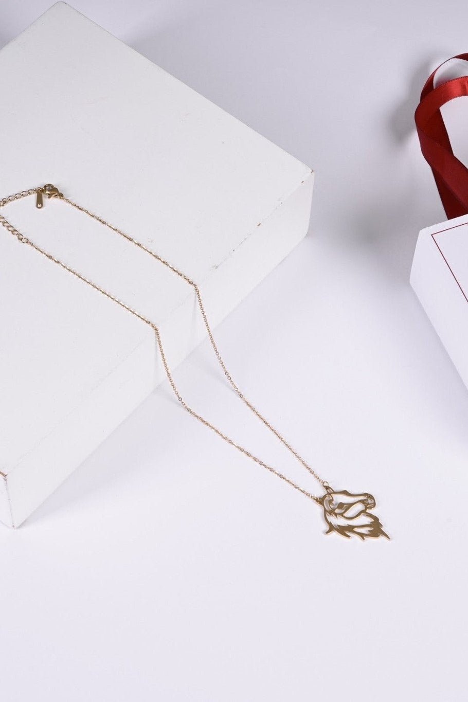 Gold horse pendant with BALTO box and bag