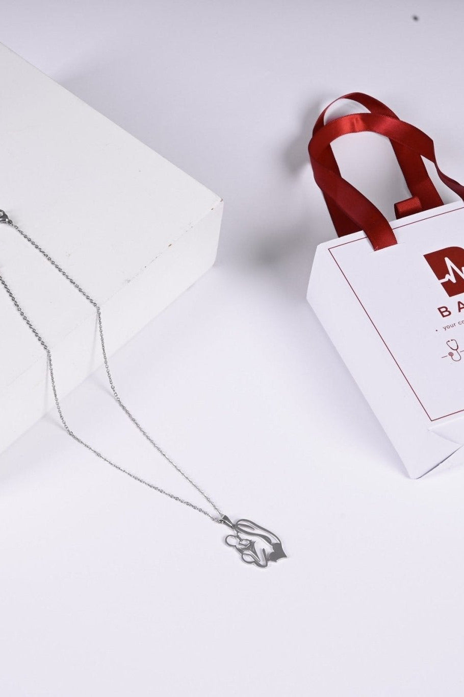 Silver mother and child pendant with BALTO box and bag